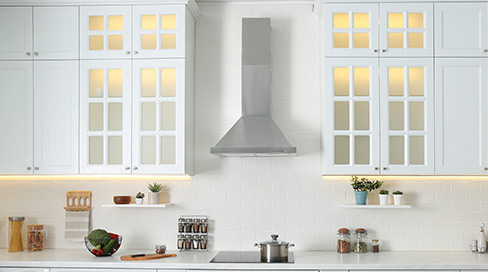 Technician installing range hood ductwork and external venting Ottawa