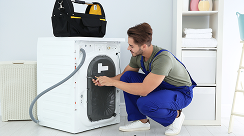 Certified technician replacing a faulty heating element during a professional electric dryer repair service in Kanata, Ottawa