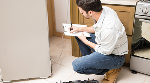 Certified Techman technician performing a comprehensive refrigerator diagnostic for same-day fridge repair in Ottawa, serving Kanata and Nepean for brands like Samsung and LG.